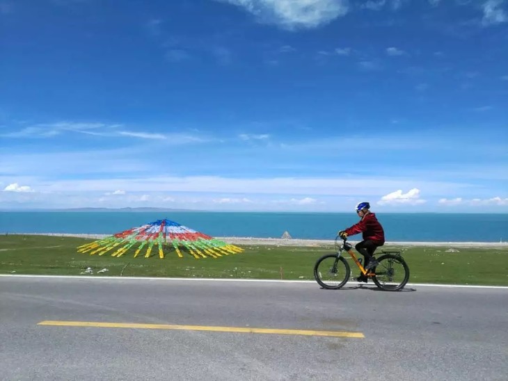 青海湖水碧波荡漾,白色的毡房点缀在远处,而且环湖的路况极好